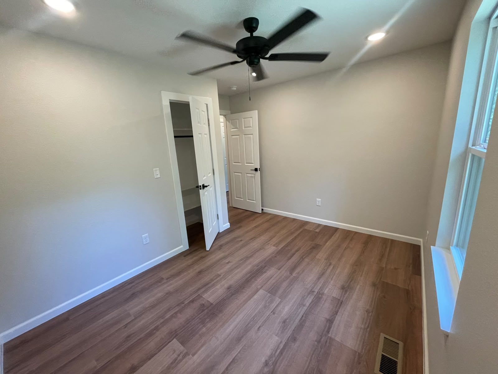 Bedroom with walk-in closet beyond