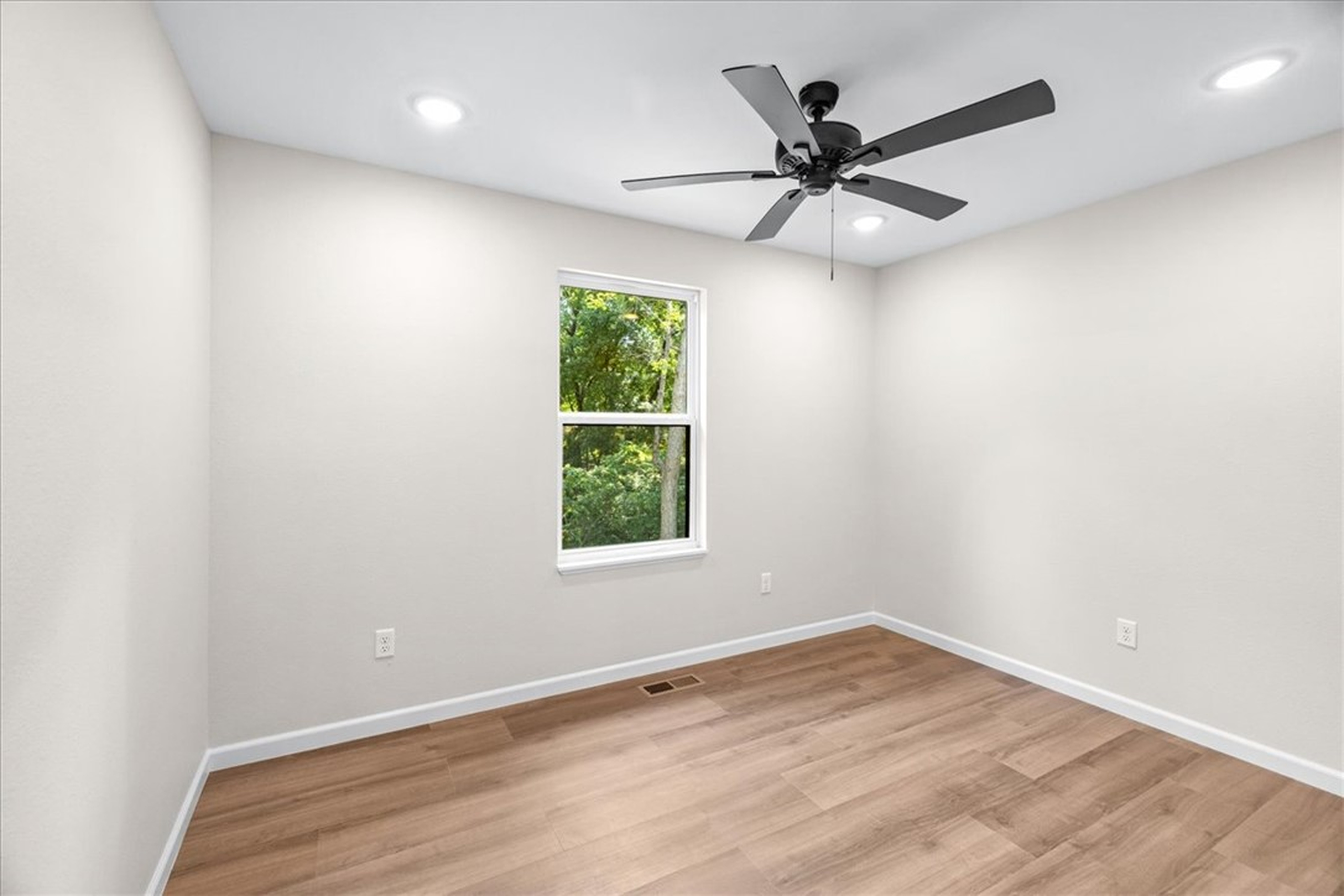 Bedroom with tree view and ceiling fan