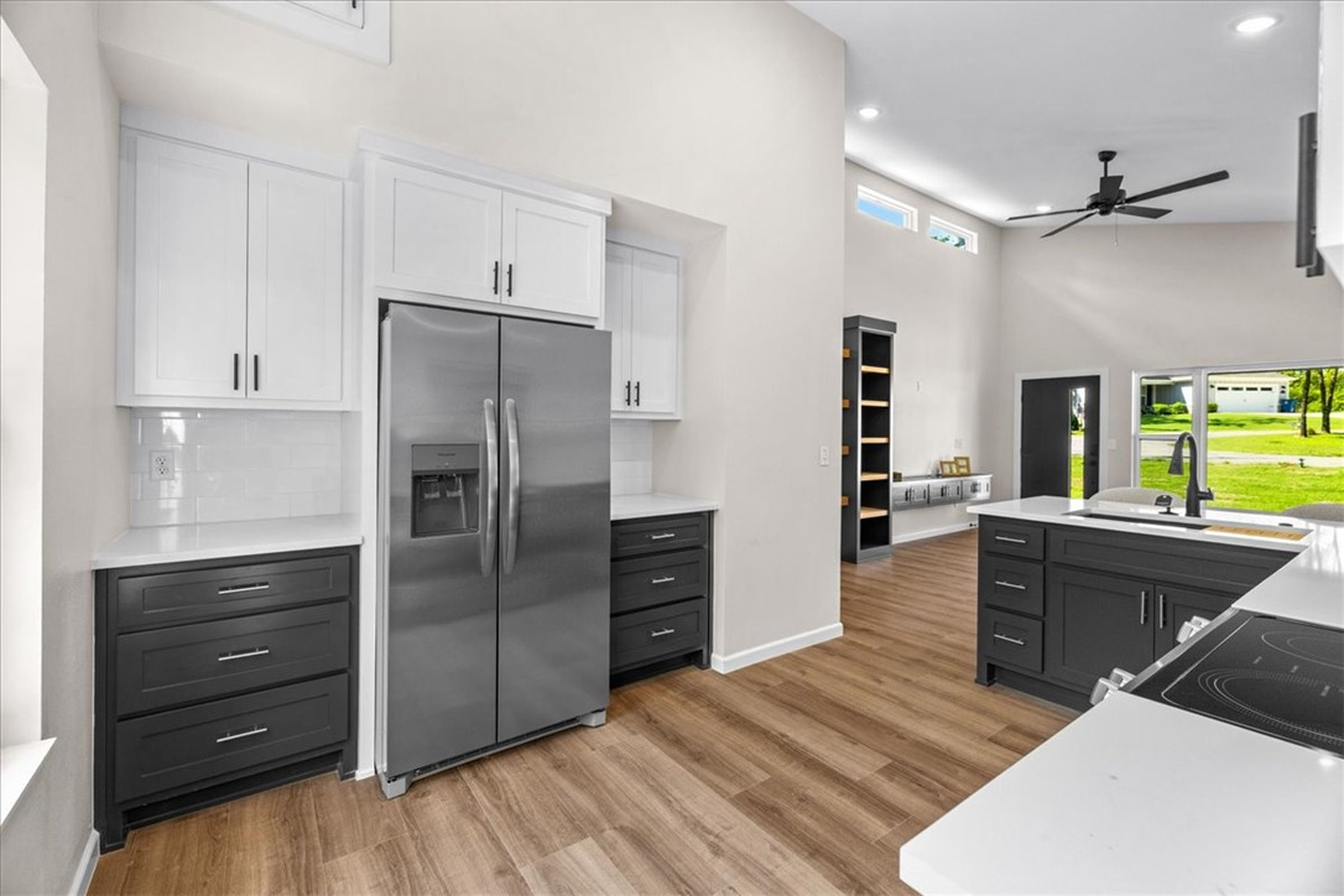 Kitchen range, microwave, and wooded window