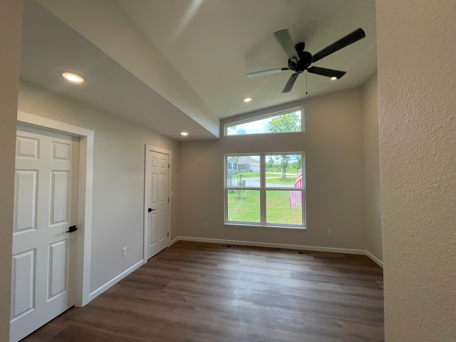 Bedroom with vaulted light and street view